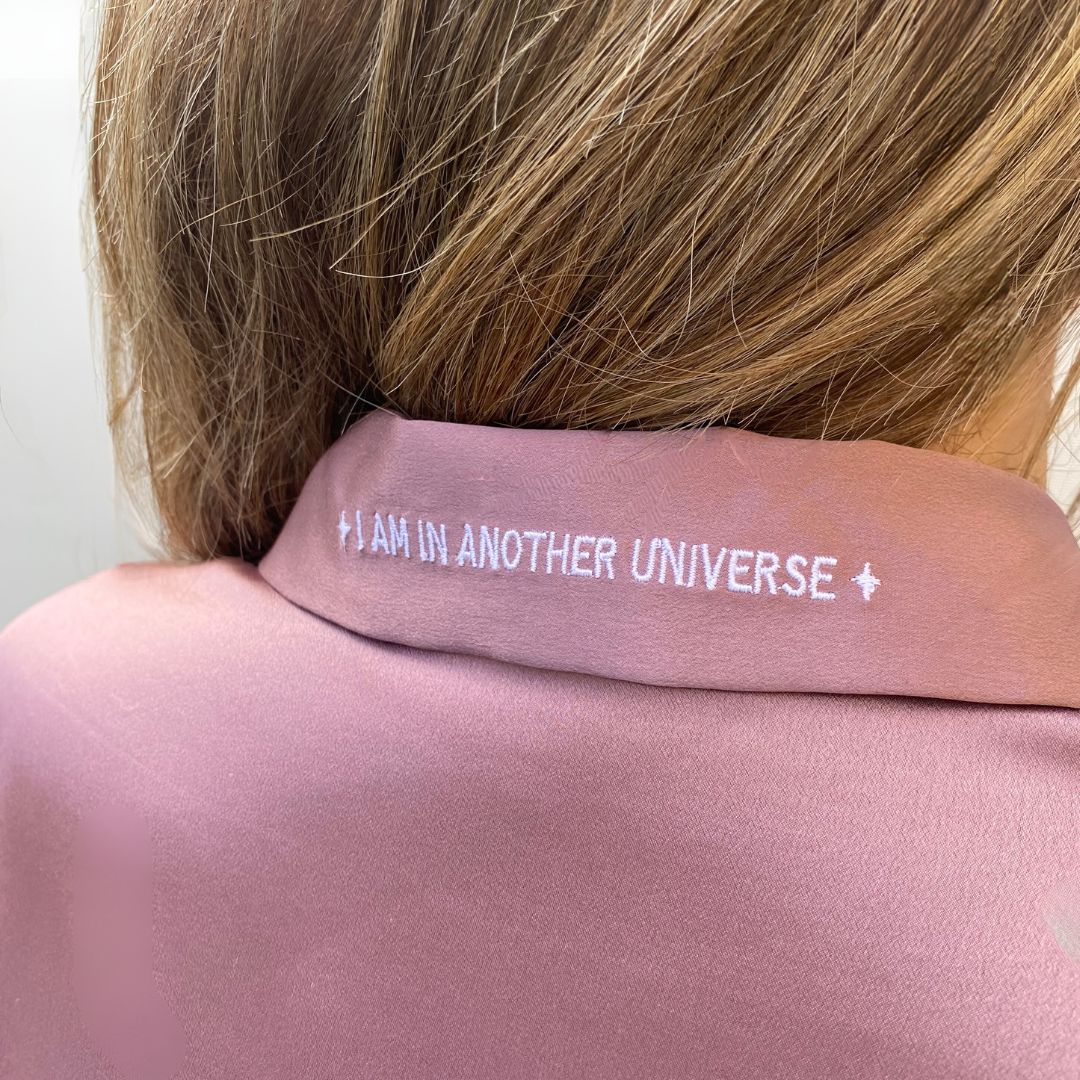 pijama de seda largo rosa de herriet con bordado en el cuello que pone "i am in another universe"