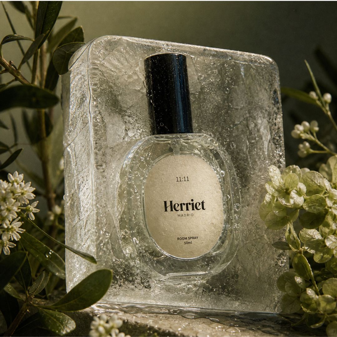 Herriet room spray bottle in a decorative ice box with greenery around