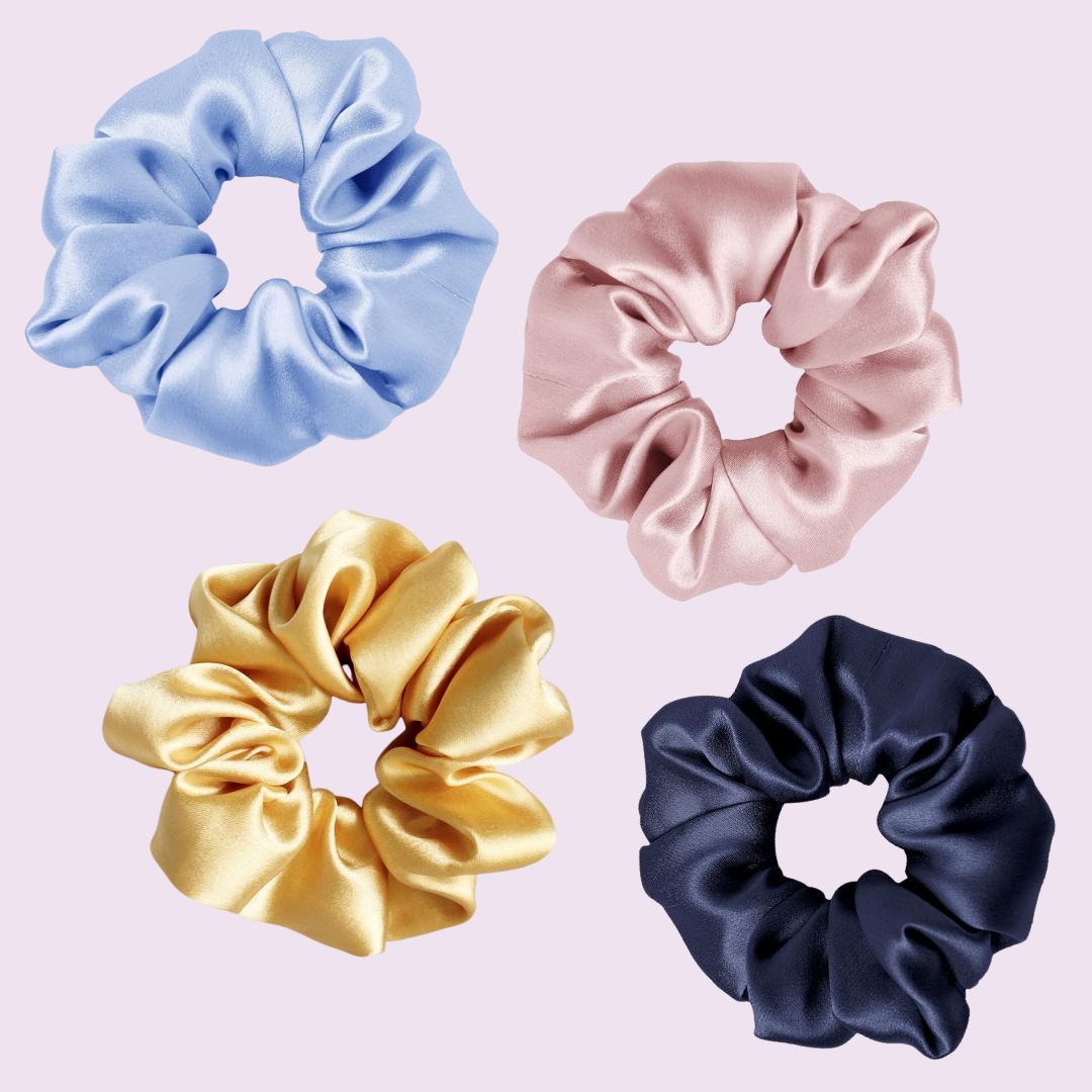 Four silk scrunchies in blue, pink, gold, and navy on a light purple background. Found on herriet.com